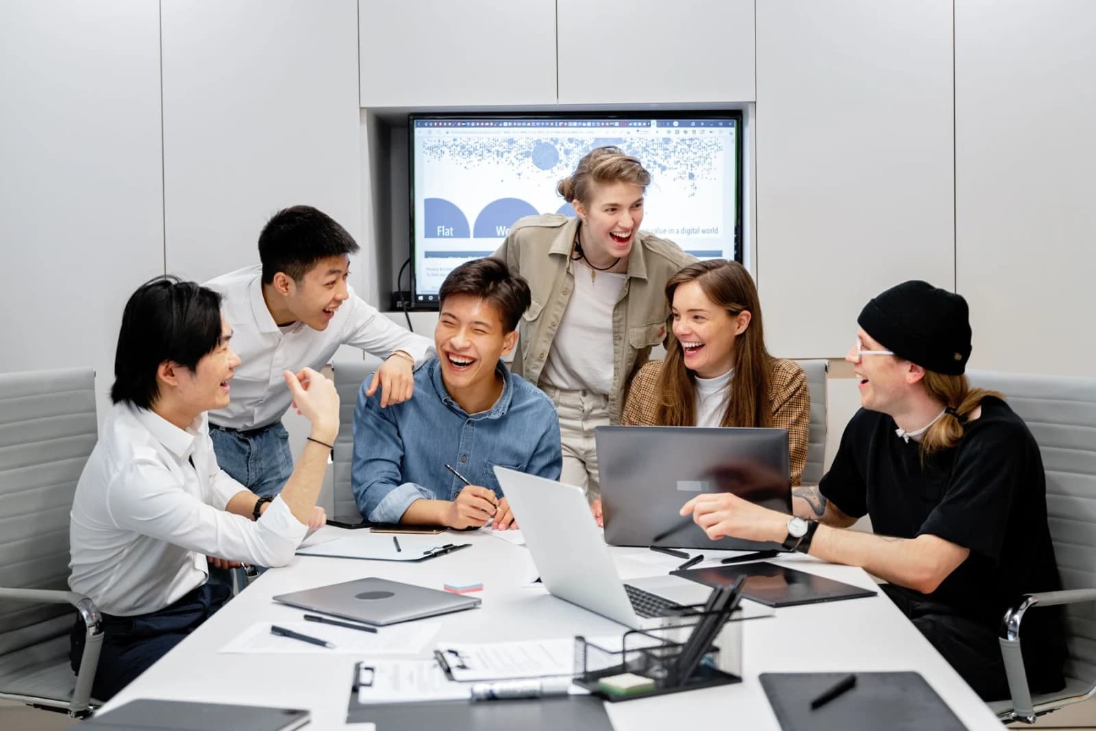 Nexzem team members collaborating around a laptop