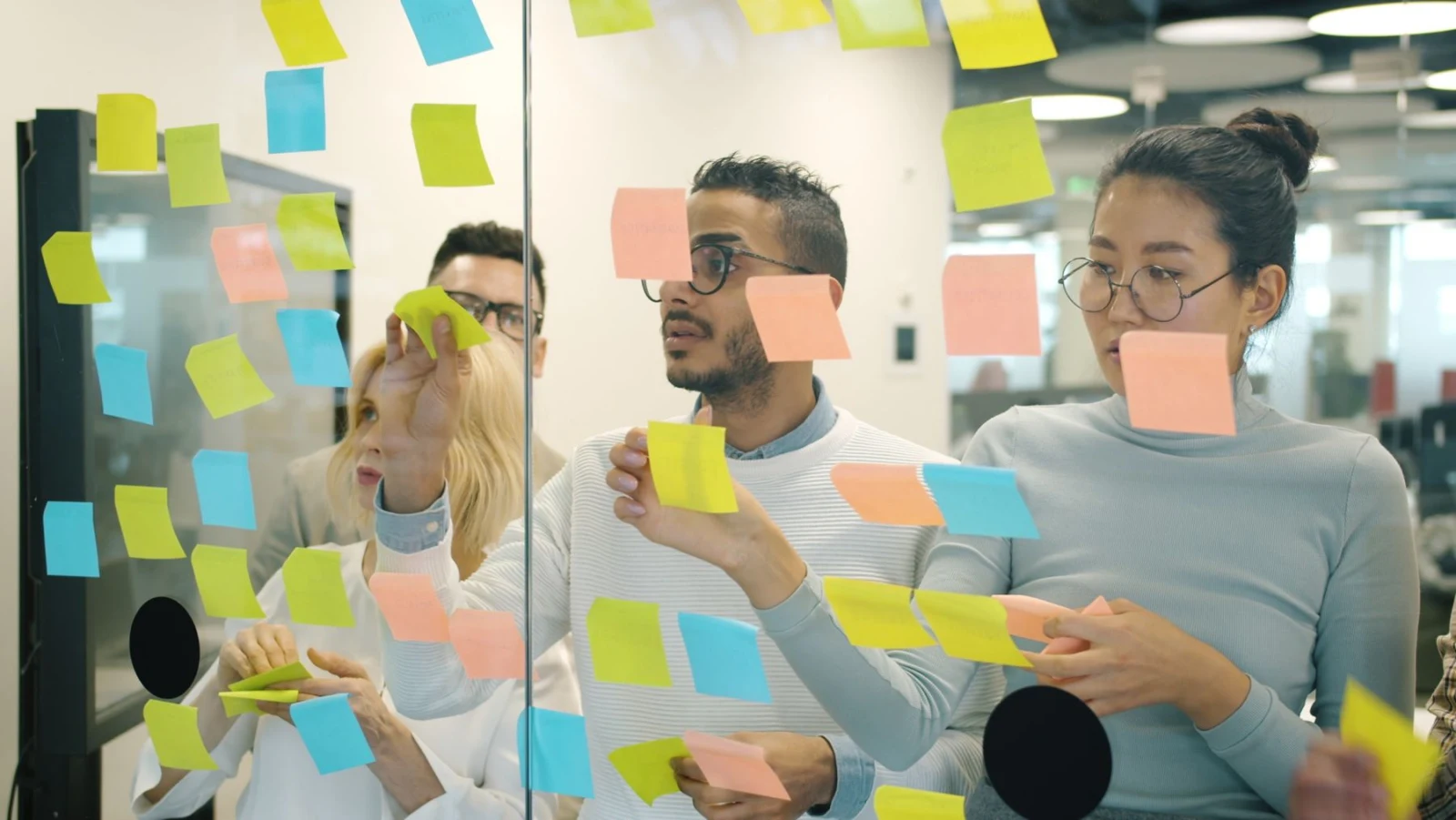 Designers and engineers planning on a whiteboard